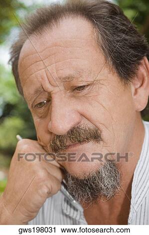 Stock Image - Close-up of a mature man looking serious. Fotosearch