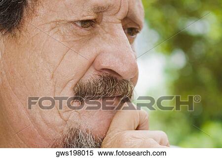 Close-up of a mature man looking serious View Large Photo Image Stock Photography - Close-up of a mature man looking serious. Fotosearch