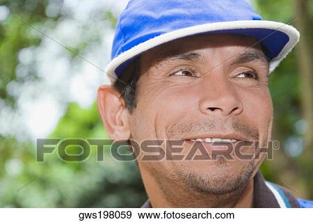 Close-up of a mature man smiling and looking away View Large Photo Image Stock Photo - Close-up of a mature man smiling and looking away. Fotosearch