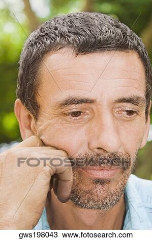 Stock Image - Close-up of a mature man thinking. Fotosearch