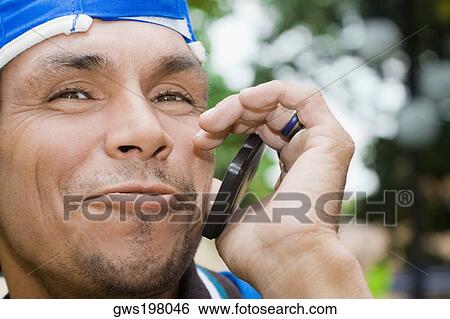 Close-up of a mature man using a mobile phone and smirking View Large Photo Image Stock Photograph - Close-up of a mature man using a mobile phone and smirking. Fotosearch