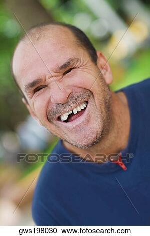 Stock Image - Close-up of a mid adult man laughing. Fotosearch