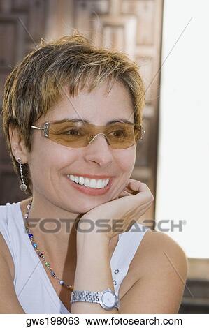 Close-up of a mid adult woman smiling View Large Photo Image Stock Image - Close-up of a mid adult woman smiling. Fotosearch