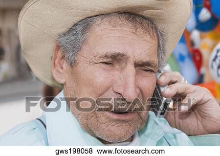 Stock Photo - Close-up of a senior man talking on a mobile phone. Fotosearch