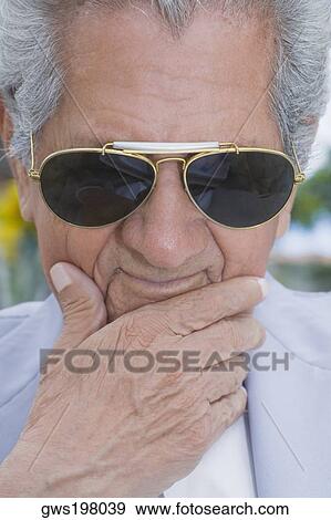 Close-up of a senior man wearing sunglasses and thinking View Large Photo Image Stock Photo - Close-up of a senior man wearing sunglasses and thinking. Fotosearch