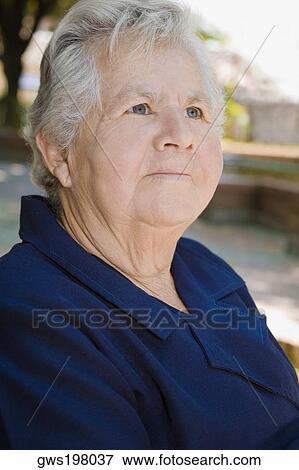 Close-up of a senior woman looking up View Large Photo Image Stock Photo - Close-up of a senior woman looking up. Fotosearch