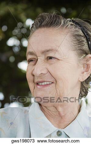 Close-up of a senior woman smiling View Large Photo Image Stock Image - Close-up of a senior woman smiling. Fotosearch
