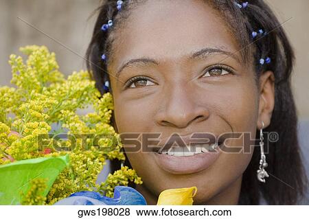 Close-up of a young woman smiling View Large Photo Image Stock Photo - Close-up of a young woman smiling. Fotosearch