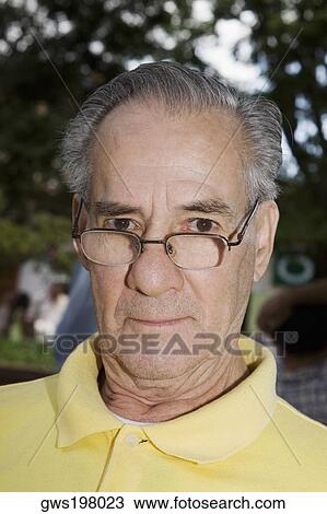 Portrait of a mature man wearing eyeglasses and staring View Large Photo Image Stock Image - Portrait of a mature man wearing eyeglasses and staring. Fotosearch