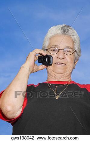 Stock Image - Portrait of a mature woman talking on a mobile phone. Fotosearch