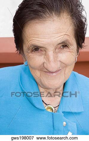 Portrait of a senior woman smiling View Large Photo Image Stock Photo - Portrait of a senior woman smiling. Fotosearch