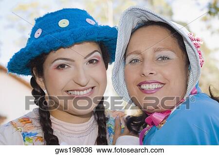 Portrait of a young woman and a mid adult woman smiling View Large Photo Image Stock Photograph - Portrait of a young woman and a mid adult woman smiling. Fotosearch