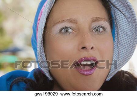 Portrait of a young woman looking surprised View Large Photo Image Stock Photo - Portrait of a young woman looking surprised. Fotosearch