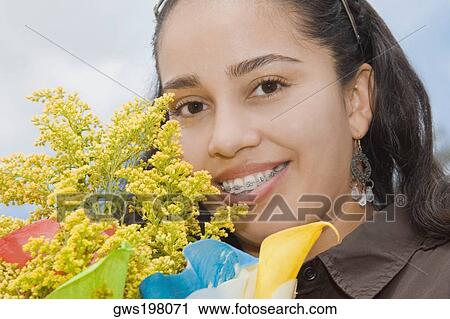 Stock Image - Portrait of a young woman smiling. Fotosearch