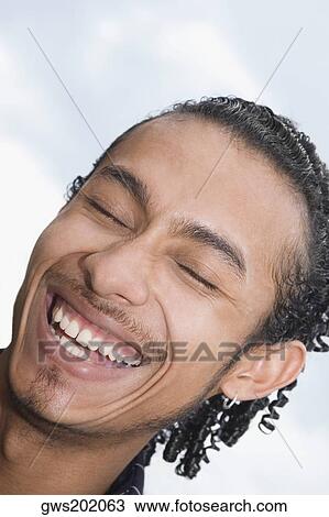 Close-up of a young man smiling View Large Photo Image Stock Image - Close-up of a young man smiling. Fotosearch
