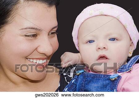 Stock Photograph - Close-up of a young woman holding her son. Fotosearch