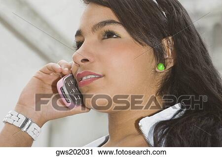 Close-up of a young woman using a mobile phone View Large Photo Image Stock Image - Close-up of a young woman using a mobile phone. Fotosearch