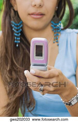 Close-up of a young woman using a mobile phone View Large Photo Image Stock Image - Close-up of a young woman using a mobile phone. Fotosearch