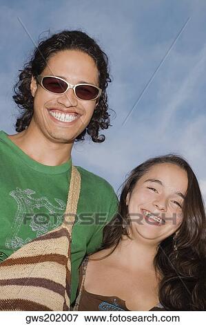 Portrait of a young couple smiling View Large Photo Image Stock Photo - Portrait of a young couple smiling. Fotosearch