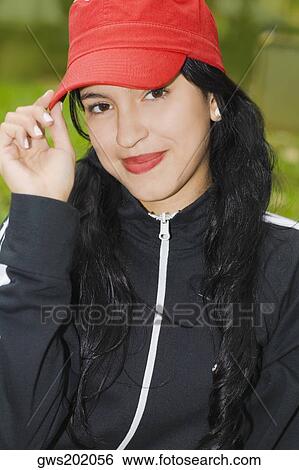 Portrait of a young woman wearing a baseball cap View Large Photo Image Stock Photograph - Portrait of a young woman wearing a baseball cap. Fotosearch