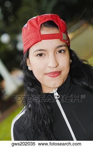 Portrait of a young woman wearing a baseball cap View Large Photo Image Stock Photography - Portrait of a young woman wearing a baseball cap. Fotosearch