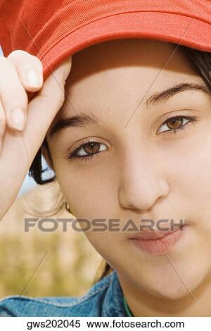 Portrait of a young woman wearing a baseball cap View Large Photo Image Stock Photography - Portrait of a young woman wearing a baseball cap. Fotosearch