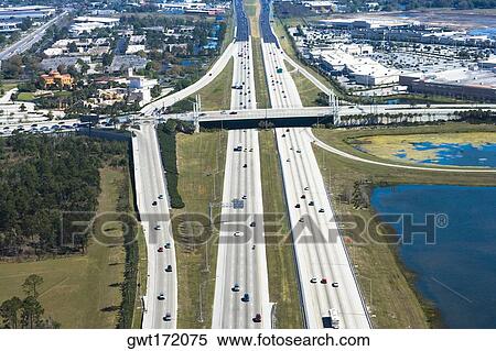Aerial view of vehicles moving on multiple lane highways, Interstate 4, Orlando, Florida, USA View Large Photo Image Stock Photography - Aerial view of vehicles moving on multiple lane highways, Interstate 4, Orlando, Florida, USA. Fotosearch