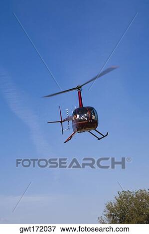 Low angle view of a helicopter flying, Orlando, Florida, USA View Large Photo Image Stock Photo - Low angle view of a helicopter flying, Orlando, Florida, USA. Fotosearch