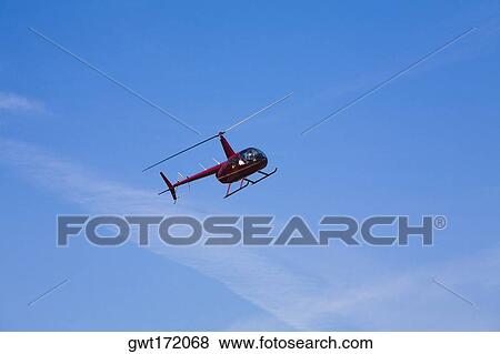 Stock Photo - Low angle view of a helicopter in flight. Fotosearch