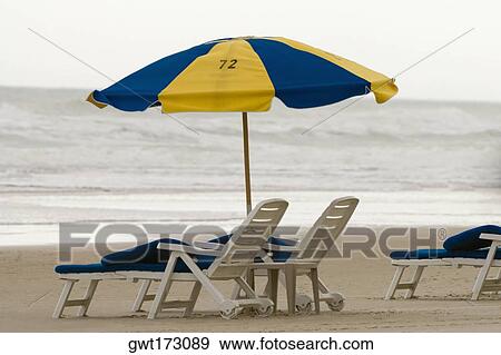 Beach umbrella and lounge chair View Large Photo Image Stock Photo - Beach umbrella and lounge chair. Fotosearch