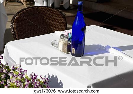 Close-up of a bottle and a salt shaker on a table, South Beach, Miami Beach, Florida, USA View Large Photo Image Stock Photograph - Close-up of a bottle and a salt shaker on a table, South Beach, Miami Beach, Florida, USA. Fotosearch