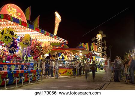 Stock Photograph - Group of people in an amusement park, Riverfront Park, Cocoa Beach, Florida, USA. Fotosearch