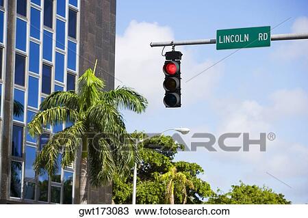 Stock Image - Low angle view of a traffic light and a signboard, South Beach, Miami Beach, Florida, USA. Fotosearch