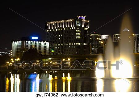 Fountains lit up at night in front of buildings, Orlando, Florida, USA View Large Photo Image Stock Image - Fountains lit up at night in front of buildings, Orlando, Florida, USA. Fotosearch