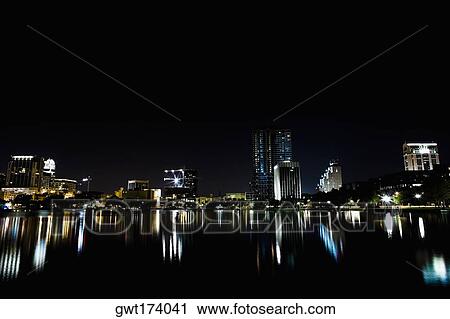 Reflection of buildings in a lake at night, Orlando, Florida, USA View Large Photo Image Stock Image - Reflection of buildings in a lake at night, Orlando, Florida, USA. Fotosearch