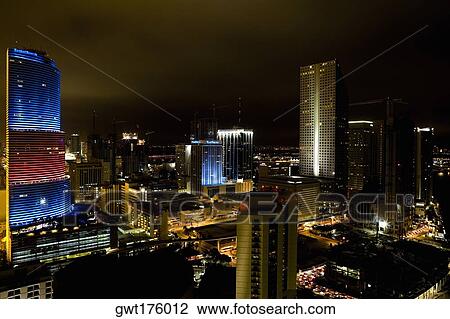 Stock Image - High angle view of a city lit up at night. Fotosearch