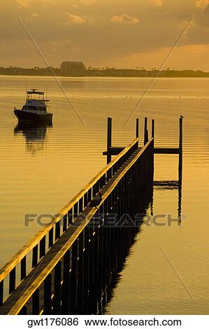 Pier and a boat in the sea, St. Augustine Beach, Florida, USA View Large Photo Image Stock Photograph - Pier and a boat in the sea, St. Augustine Beach, Florida, USA. Fotosearch