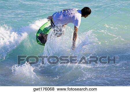 Stock Photo - Rear view of a man on a surfboard, South Beach, Miami, Florida, USA. Fotosearch