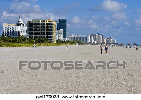 Stock Photo - Tourists walking on the beach, South Beach, Miami Beach, Florida, USA. Fotosearch