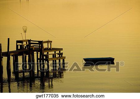 Boat near a pier with a fishing net, St. Augustine Beach, Florida, USA View Large Photo Image Stock Photography - Boat near a pier with a fishing net, St. Augustine Beach, Florida, USA. Fotosearch