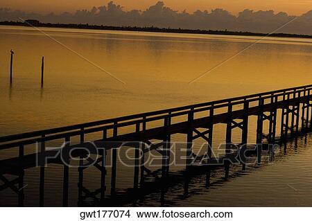 Silhouette of a pier in the sea, St. Augustine Beach, Florida, USA View Large Photo Image Picture - Silhouette of a pier in the sea, St. Augustine Beach, Florida, USA. Fotosearch