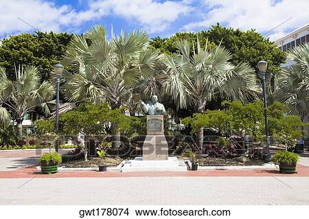 Bust on a pedestal in front of trees, Sir Milo Boughton Butler, Rawson Square, Nassau, Bahamas View Large Photo Image Picture - Bust on a pedestal in front of trees, Sir Milo Boughton Butler, Rawson Square, Nassau, Bahamas. Fotosearch