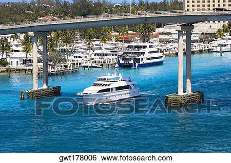 Cruise ship under a bridge in the sea, Western Bridge, Paradise Island, Bahamas View Large Photo Image Stock Photograph - Cruise ship under a bridge in the sea, Western Bridge, Paradise Island, Bahamas. Fotosearch