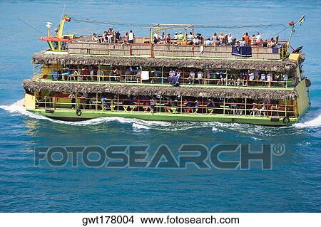 High angle view of a group of people in a tourboat in water, Nassau, Bahamas View Large Photo Image Picture - High angle view of a group of people in a tourboat in water, Nassau, Bahamas. Fotosearch