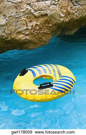 Inflatable ring floating on water, Cable Beach, Nassau, Bahamas View Large Photo Image Stock Photo - Inflatable ring floating on water, Cable Beach, Nassau, Bahamas. Fotosearch