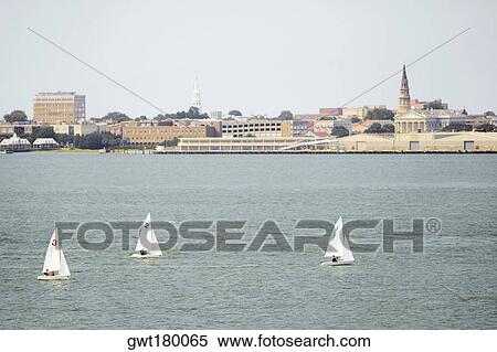 Stock Photography - Sailboats in the river with buildings in the background, Patriot's Point, Charleston Harbor, Charleston, South Carolina, USA. Fotosearch