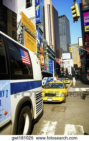 Bus and yellow taxi moving on a road, Times Square, Manhattan, New York City, New York State, USA View Large Photo Image Stock Photography - Bus and yellow taxi moving on a road, Times Square, Manhattan, New York City, New York State, USA. Fotosearch