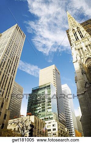 Low angle view of skyscrapers in a city, St. Patrick's Cathedral, Manhattan, New York City, New York State, USA View Large Photo Image Stock Photography - Low angle view of skyscrapers in a city, St. Patrick's Cathedral, Manhattan, New York City, New York State, USA. Fotosearch