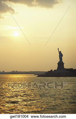 Silhouette of a statue at dusk, Statue Of Liberty, New York City, New York State, USA View Large Photo Image Picture - Silhouette of a statue at dusk, Statue Of Liberty, New York City, New York State, USA. Fotosearch