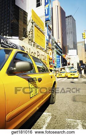 Yellow taxi on a road, Times Square, Manhattan, New York City, New York State, USA View Large Photo Image Stock Photograph - Yellow taxi on a road, Times Square, Manhattan, New York City, New York State, USA. Fotosearch